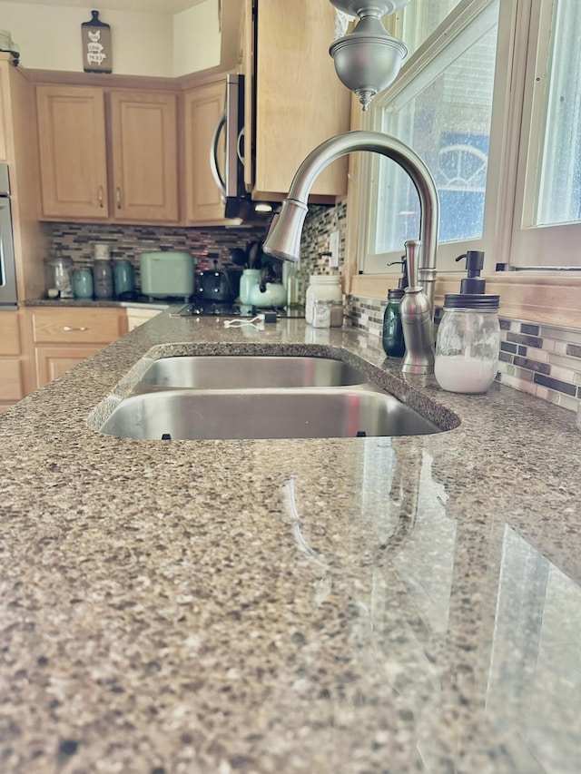 3125 Old Bull Rd, Eubank, KY 42567 - kitchen view of tasteful backsplash, a sink, stainless steel microwave, oven, and light stone counters