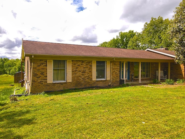 3125 Old Bull Rd, Eubank, KY 42567 - single story home with a front yard, brick siding, a shingled roof, and a shed
