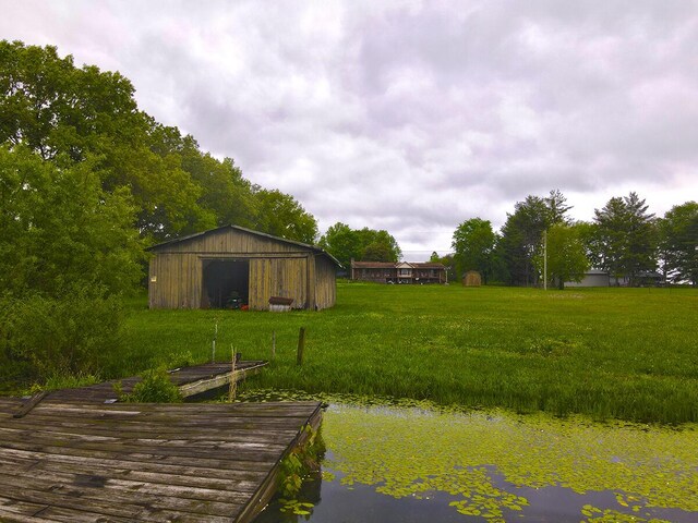 3125 Old Bull Rd, Eubank, KY 42567 - view of grassy yard featuring a dock, an outbuilding, and an outdoor structure