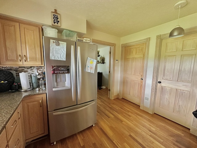 3125 Old Bull Rd, Eubank, KY 42567 - kitchen featuring stainless steel refrigerator with ice dispenser, light wood-type flooring, backsplash, a textured ceiling, and stone counters