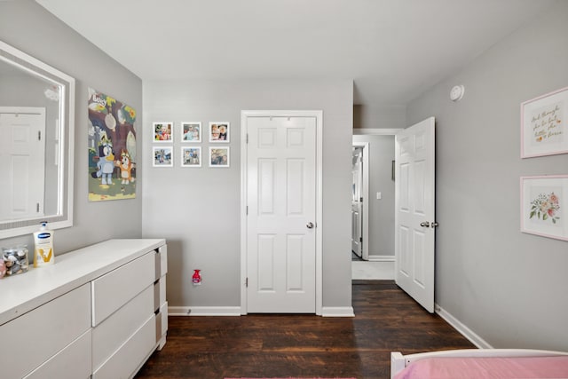 bedroom featuring dark wood-style floors and baseboards