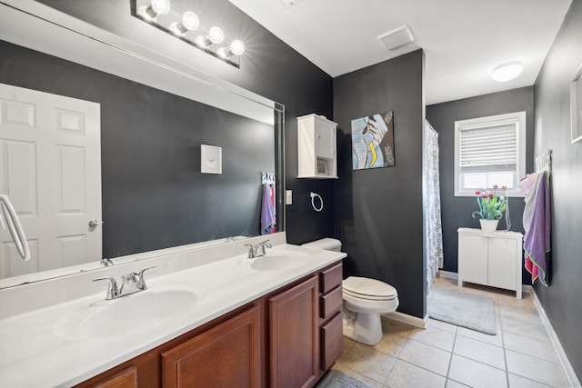 bathroom featuring toilet, double vanity, tile patterned flooring, baseboards, and curtained shower