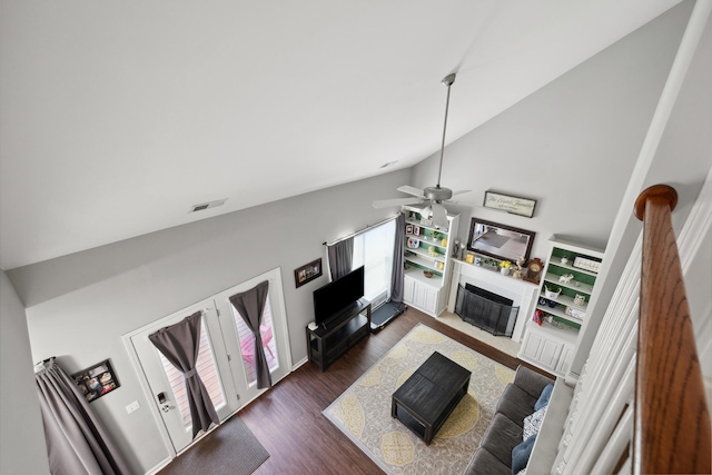 living room with a fireplace with flush hearth, high vaulted ceiling, wood finished floors, and ceiling fan
