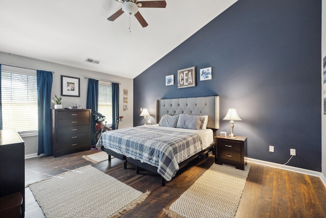 bedroom with vaulted ceiling, baseboards, wood finished floors, and ceiling fan