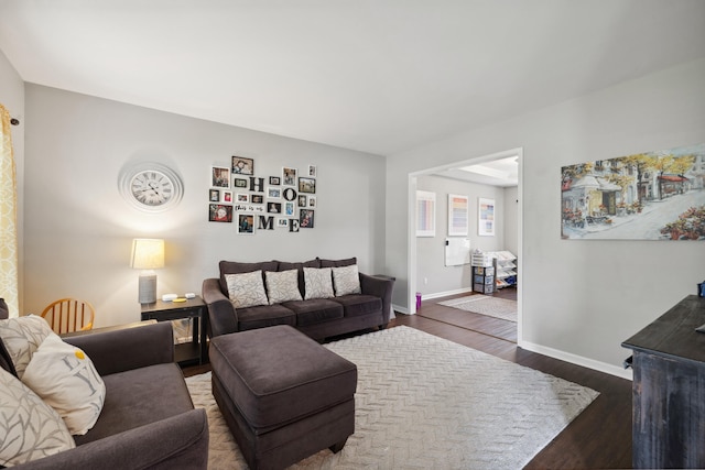 living room featuring wood finished floors and baseboards