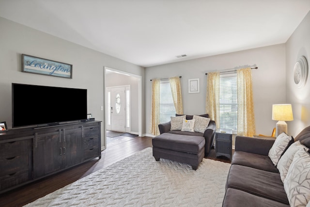 living room featuring wood finished floors and baseboards