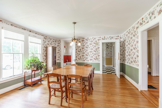 416 W Main St, Harrodsburg, KY 40330 - dining space with wallpapered walls, wainscoting, light wood-type flooring, and baseboards