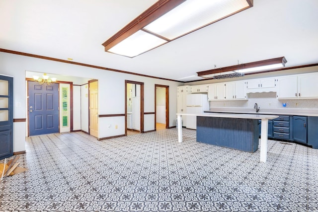 10708 Battlefield Memorial Hwy, Berea, KY 40403 - kitchen featuring freestanding refrigerator, white cabinetry, a chandelier, light countertops, and a sink