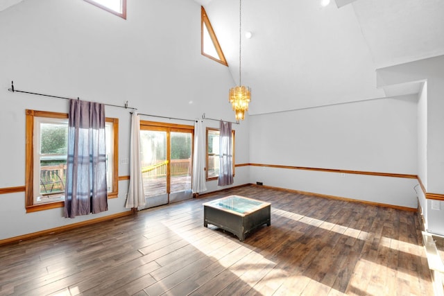 10708 Battlefield Memorial Hwy, Berea, KY 40403 - unfurnished living room with high vaulted ceiling, a chandelier, hardwood / wood-style floors, and baseboards