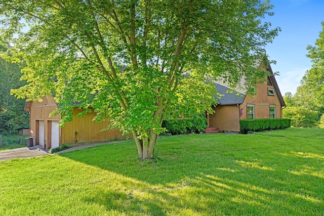 10708 Battlefield Memorial Hwy, Berea, KY 40403 - view of grassy yard with a garage and asphalt driveway