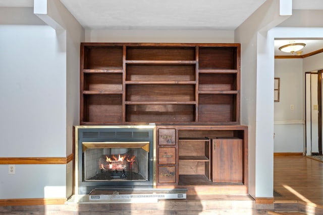 10708 Battlefield Memorial Hwy, Berea, KY 40403 - detailed view of wood finished floors, baseboards, and a warm lit fireplace