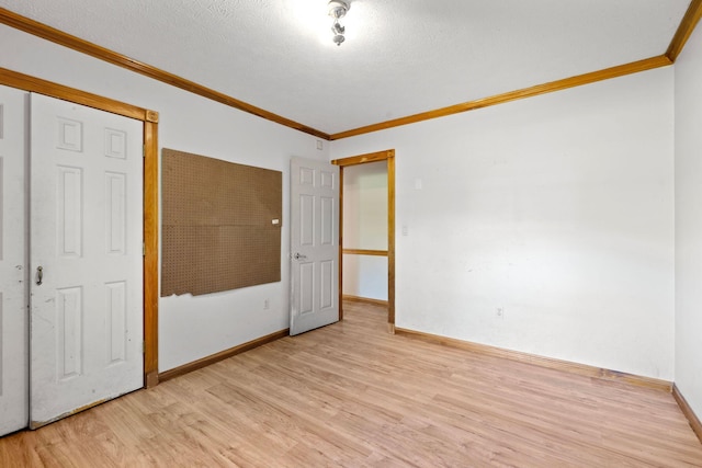 10708 Battlefield Memorial Hwy, Berea, KY 40403 - unfurnished room with light wood-style flooring, crown molding, baseboards, and a textured ceiling