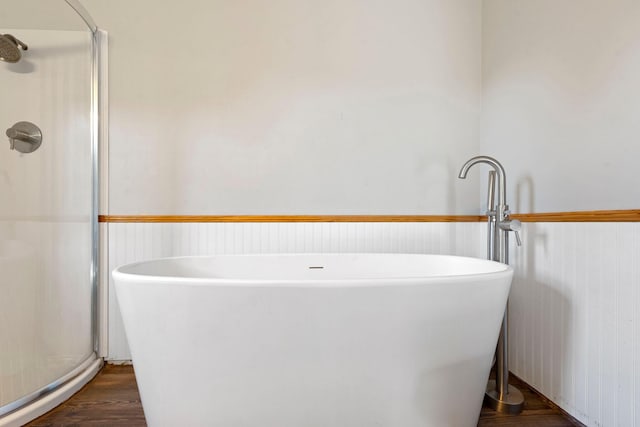 10708 Battlefield Memorial Hwy, Berea, KY 40403 - bathroom with wood finished floors, a stall shower, wainscoting, and a soaking tub