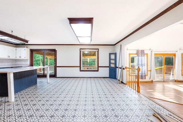 10708 Battlefield Memorial Hwy, Berea, KY 40403 - unfurnished living room featuring crown molding, baseboards, and light carpet