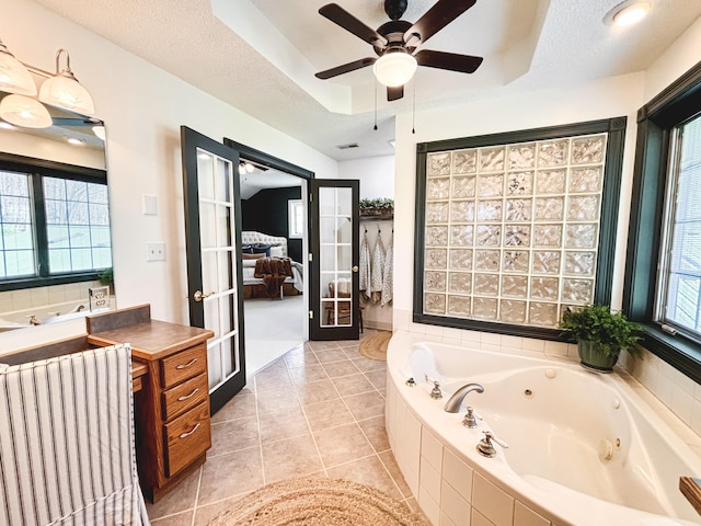 1610 Steele Branch Rd, West Liberty, KY 41472 - bathroom with french doors, a tub with jets, radiator, a ceiling fan, and tile patterned floors