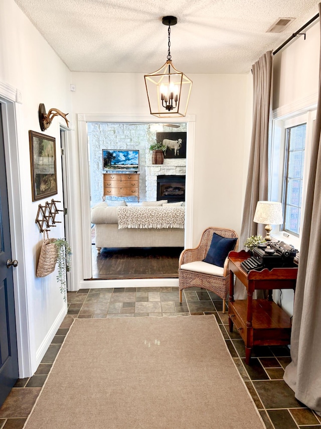 1610 Steele Branch Rd, West Liberty, KY 41472 - corridor with a textured ceiling and a chandelier
