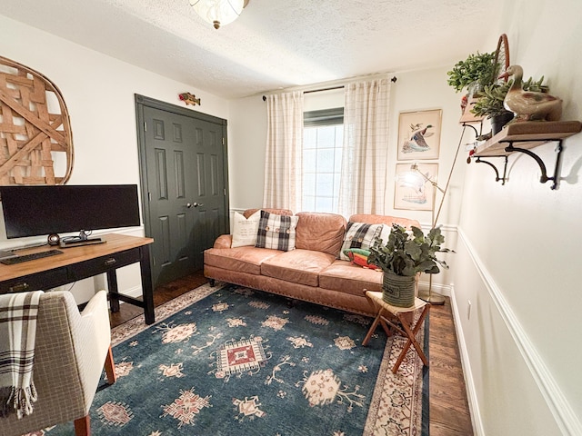 1610 Steele Branch Rd, West Liberty, KY 41472 - living area featuring wood finished floors, a textured ceiling, and baseboards