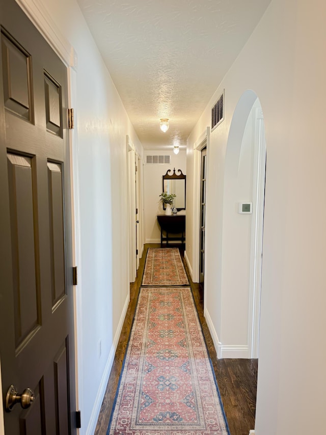 1610 Steele Branch Rd, West Liberty, KY 41472 - hall with a textured ceiling, dark wood-style floors, and baseboards