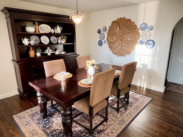 1610 Steele Branch Rd, West Liberty, KY 41472 - dining area featuring arched walkways, dark wood-style flooring, baseboards, a chandelier, and a textured ceiling