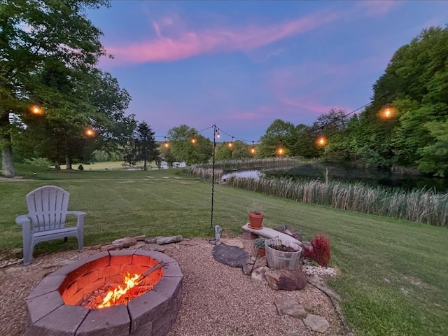 1610 Steele Branch Rd, West Liberty, KY 41472 - yard at dusk with an outdoor fire pit and a yard