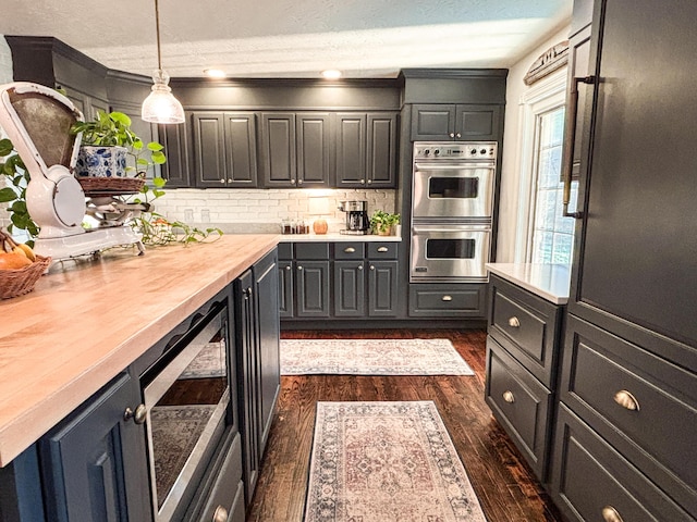 1610 Steele Branch Rd, West Liberty, KY 41472 - kitchen featuring appliances with stainless steel finishes, light countertops, dark wood-type flooring, decorative backsplash, and crown molding