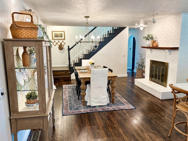 1610 Steele Branch Rd, West Liberty, KY 41472 - dining space with stairway, baseboards, wood finished floors, arched walkways, and a fireplace