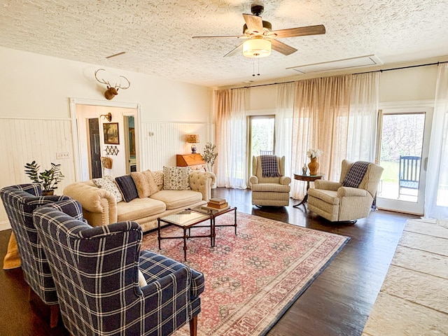 1610 Steele Branch Rd, West Liberty, KY 41472 - living room featuring a textured ceiling, a ceiling fan, dark wood-type flooring, and wainscoting