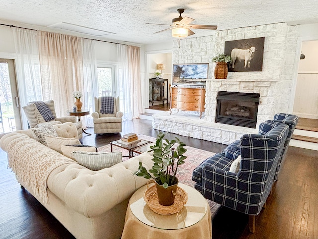 1610 Steele Branch Rd, West Liberty, KY 41472 - living room with ceiling fan, wood finished floors, a textured ceiling, and a stone fireplace
