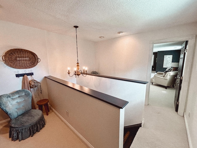 1610 Steele Branch Rd, West Liberty, KY 41472 - hall with light colored carpet, a chandelier, a textured ceiling, and baseboards