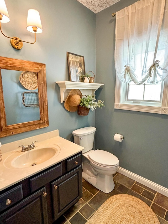 1610 Steele Branch Rd, West Liberty, KY 41472 - bathroom with toilet, vanity, baseboards, and tile patterned floors