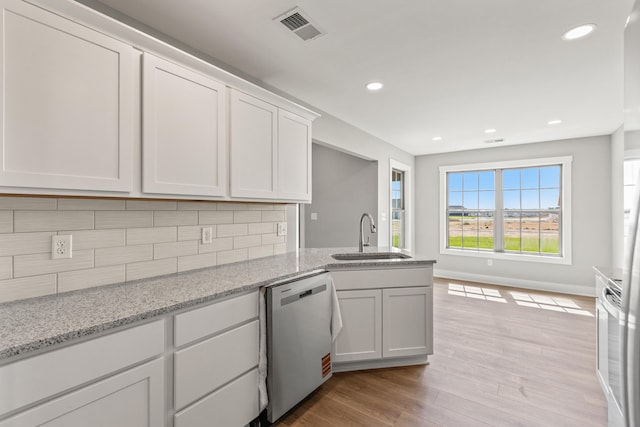 469 Wyldwood Way, Berea, KY 40403 - kitchen with stainless steel dishwasher, a sink, backsplash, light wood-type flooring, and white cabinets