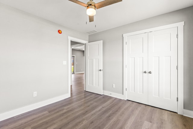469 Wyldwood Way, Berea, KY 40403 - unfurnished bedroom with wood finished floors, baseboards, a closet, and a ceiling fan