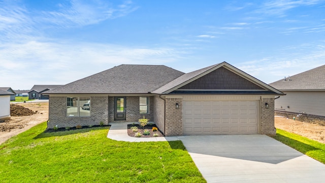 469 Wyldwood Way, Berea, KY 40403 - view of front of house featuring an attached garage, concrete driveway, brick siding, a front yard, and roof with shingles