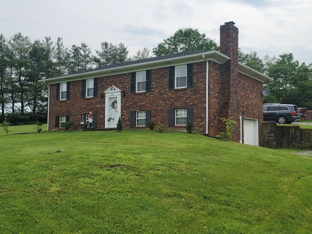 1267 Crab Orchard Rd, Lancaster, KY 40444 - bi-level home with a chimney, a front yard, brick siding, and an attached garage