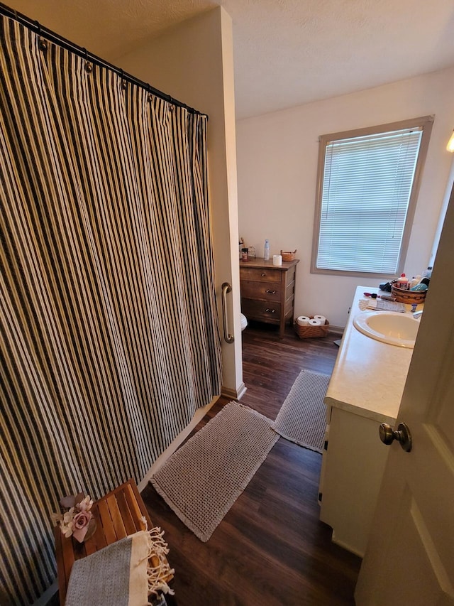 1267 Crab Orchard Rd, Lancaster, KY 40444 - full bathroom with vanity, wood finished floors, a shower with curtain, and baseboards