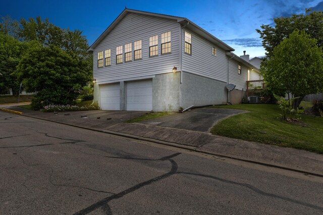 202 Strother St, Mt Sterling, KY 40353 - view of side of property featuring an attached garage, concrete driveway, central AC unit, and a lawn