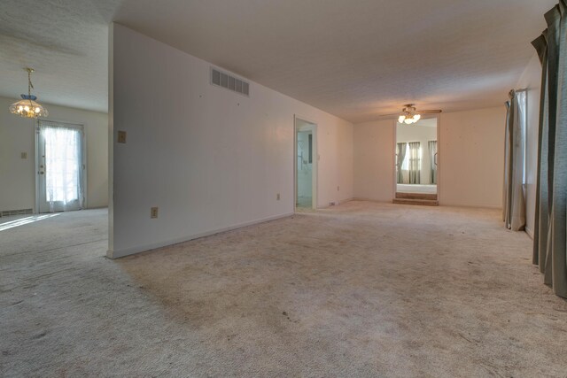 202 Strother St, Mt Sterling, KY 40353 - carpeted empty room with a chandelier