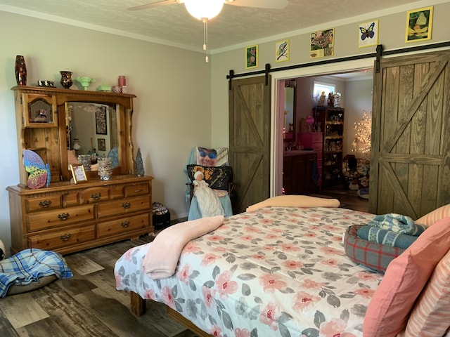 1306 Johnson Rd, Harrodsburg, KY 40330 - bedroom with a barn door, wood finished floors, crown molding, and ceiling fan