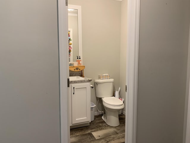 1306 Johnson Rd, Harrodsburg, KY 40330 - half bathroom featuring toilet, vanity, and wood finished floors