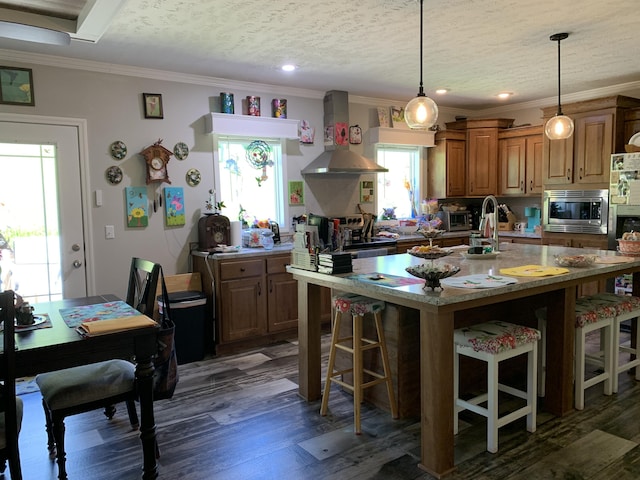1306 Johnson Rd, Harrodsburg, KY 40330 - kitchen with wall chimney exhaust hood, appliances with stainless steel finishes, a breakfast bar area, crown molding, and wood finished floors
