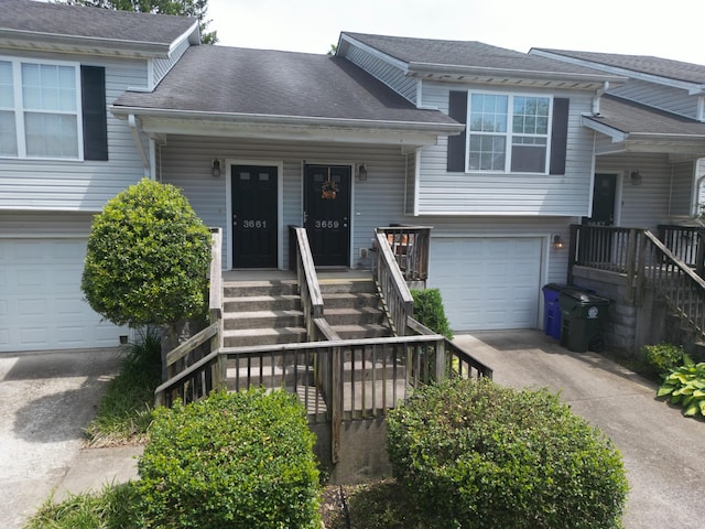 3659 Leisure Creek Ct, Lexington, KY 40517 - split level home featuring an attached garage, driveway, stairway, covered porch, and a shingled roof