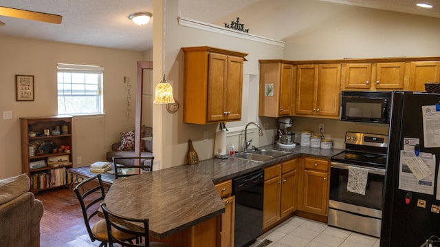 3659 Leisure Creek Ct, Lexington, KY 40517 - kitchen featuring black appliances, a sink, brown cabinets, dark countertops, and lofted ceiling