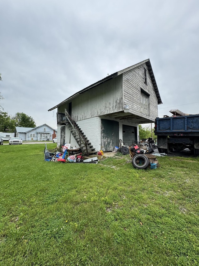 107 E N St, Carlisle, KY 40311 - back of house with a garage, a yard, and stairs