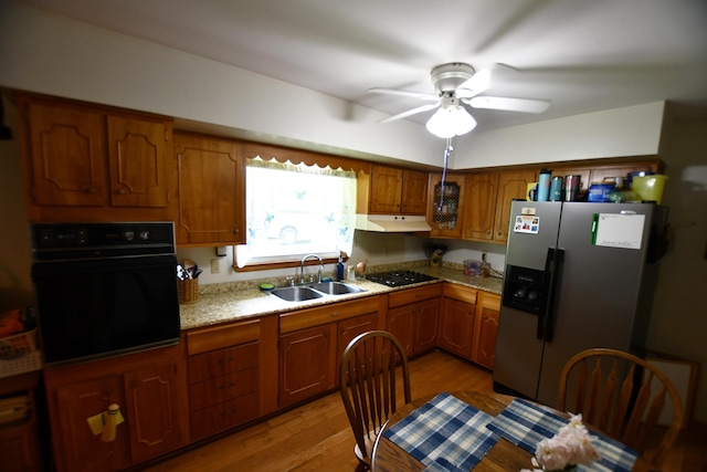 755 Mckee Rd, Irvine, KY 40336 - kitchen with black appliances, a sink, ceiling fan, brown cabinets, and light wood-style flooring