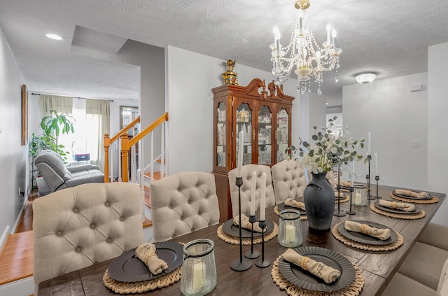 356 Weslyn Way, Nicholasville, KY 40356 - dining room with wood finished floors, a textured ceiling, a chandelier, and stairs