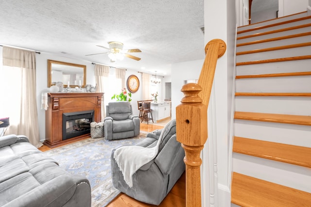 356 Weslyn Way, Nicholasville, KY 40356 - living room featuring stairway, ceiling fan, wood finished floors, healthy amount of natural light, and a textured ceiling