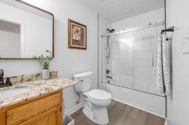 356 Weslyn Way, Nicholasville, KY 40356 - full bathroom featuring wood finished floors, a textured ceiling, toilet, vanity, and bath / shower combo with glass door