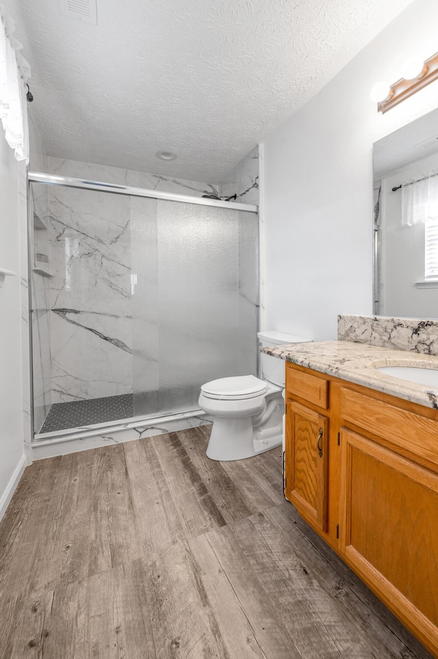 356 Weslyn Way, Nicholasville, KY 40356 - bathroom with wood finished floors, toilet, a marble finish shower, a textured ceiling, and vanity