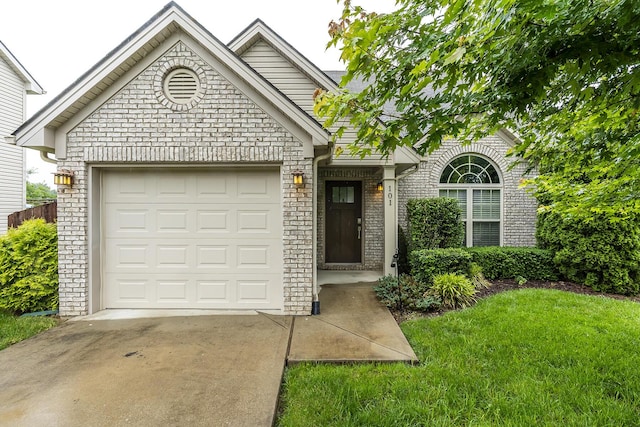 101 Brookford Way, Georgetown, KY 40324 - view of front of home featuring driveway, brick siding, a front lawn, and a garage