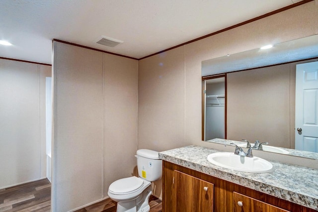 2832 Two Mile Rd, Winchester, KY 40391 - full bath featuring wood finished floors, vanity, toilet, and ornamental molding